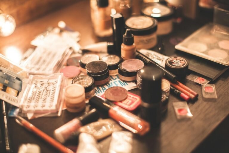 Various cosmetics and makeup products displayed on a vanity table. Ideal for beauty and fashion themes.