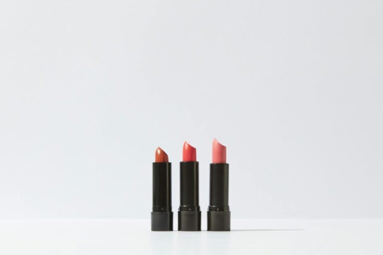 A minimalist display of three lipsticks on a white background, perfect for cosmetic themes.